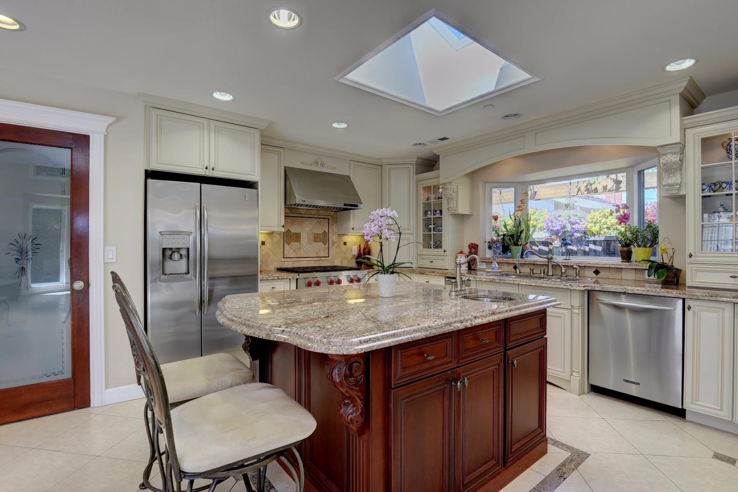 1042 Celilo Drive Sunnyvale, CA 94087 - Photo 10 of 27 a kitchen with stainless steel appliances granite countertop a sink a stove a refrigerator cabinets and chairs