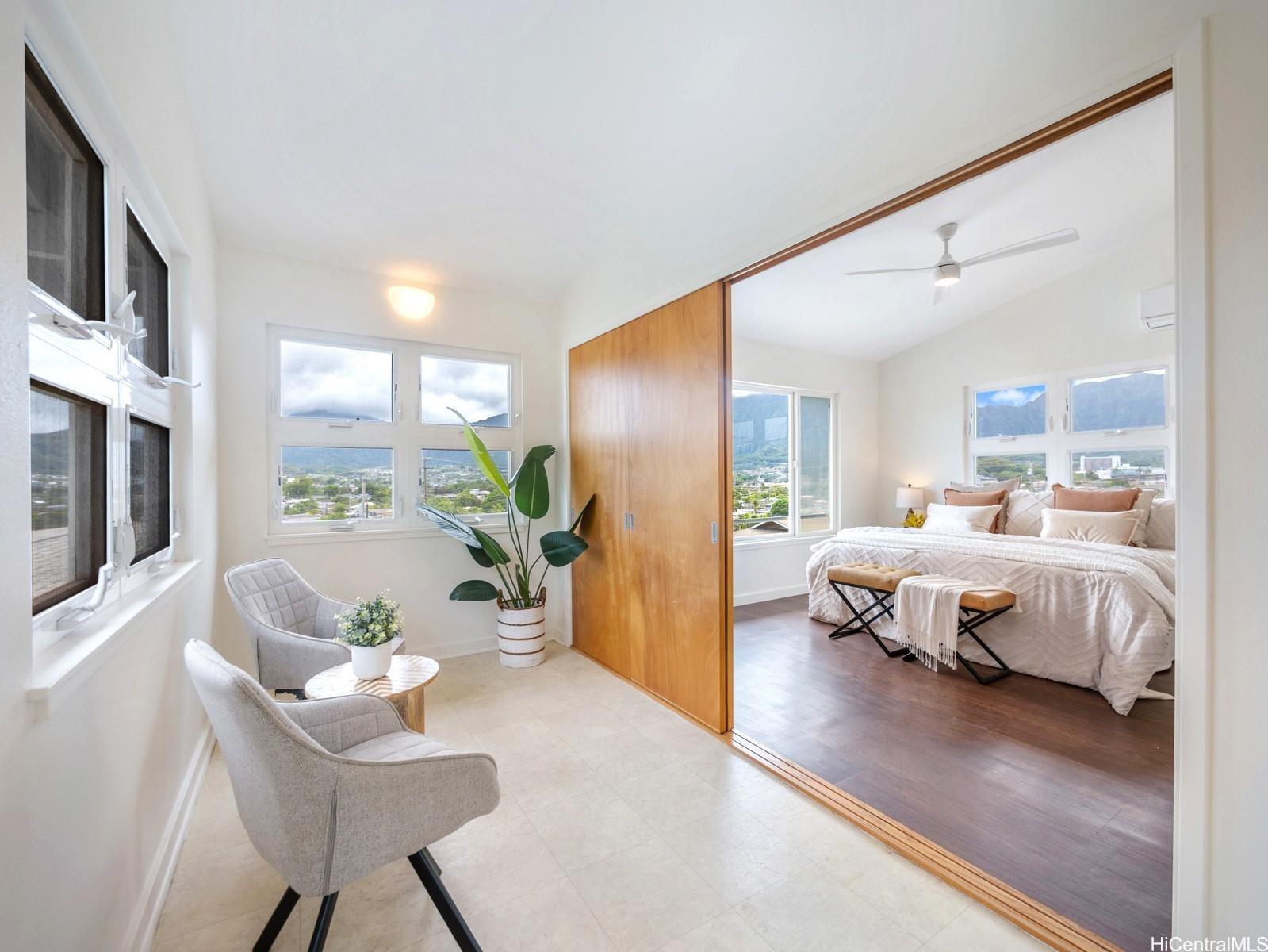 45-185 Lilipuna Road, Unit A Kaneohe, HI 96744 - Photo 13 of 22 a spacious bedroom with a bed and wooden floor