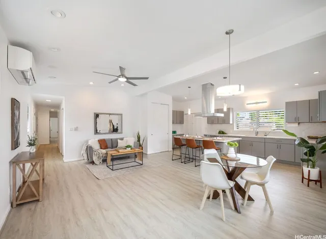 a living room with furniture and kitchen view