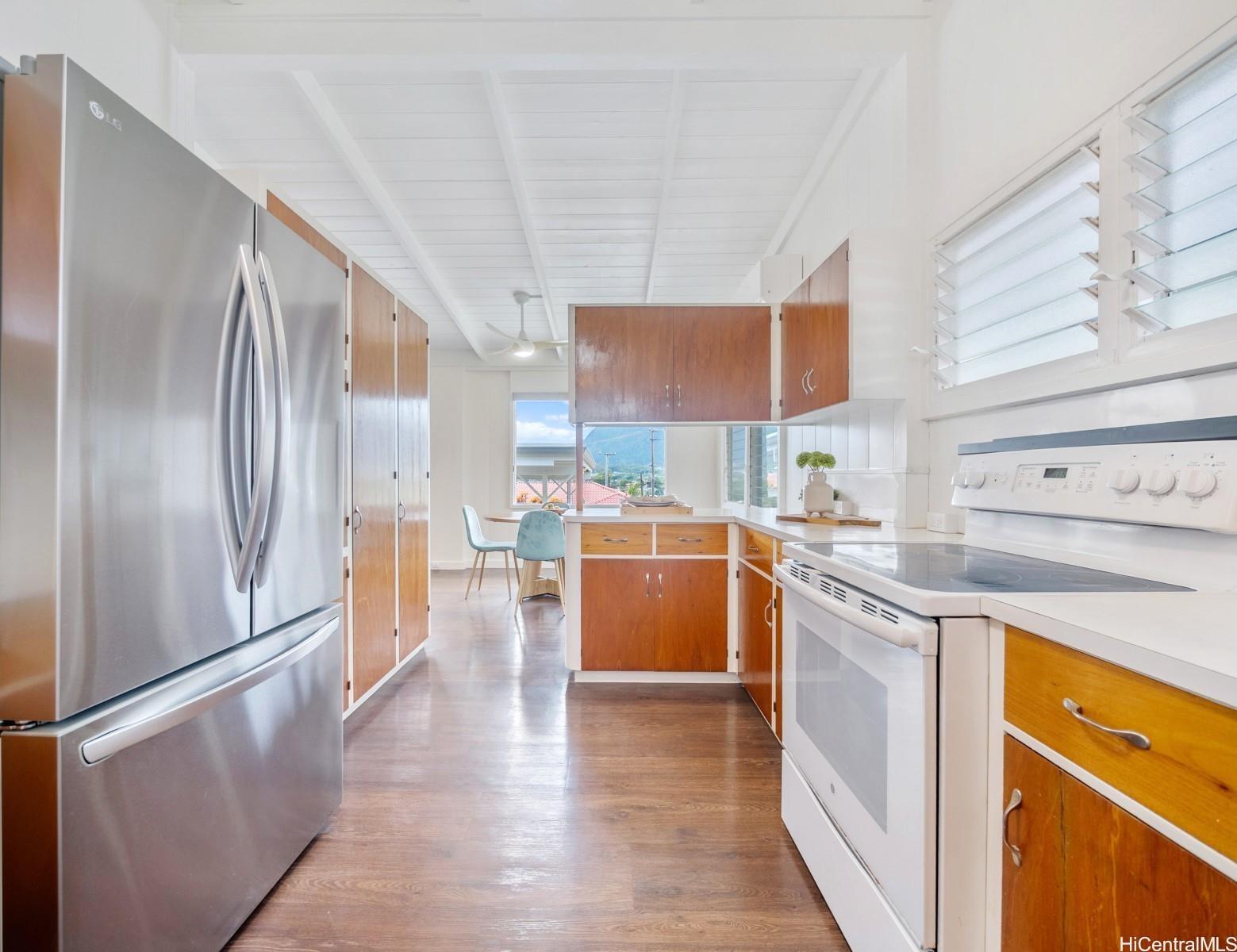 45-185 Lilipuna Road, Unit A Kaneohe, HI 96744 - Photo 16 of 22 a kitchen with stainless steel appliances granite countertop a sink a stove and a refrigerator