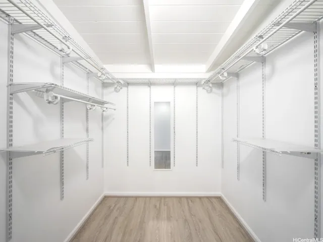 a view of a room with wooden floor and window