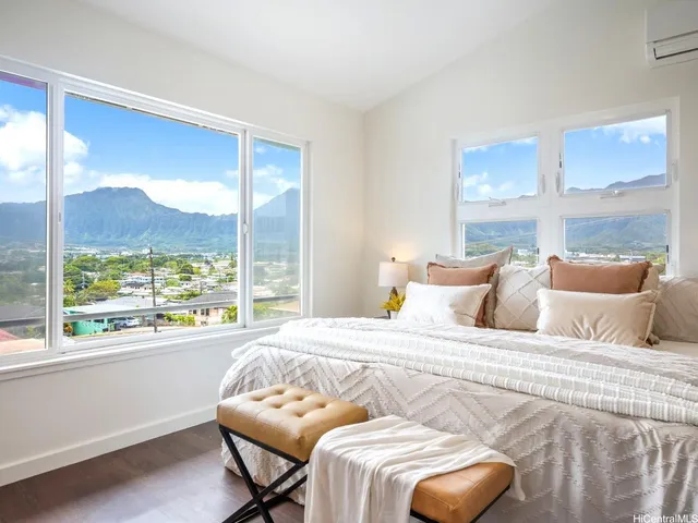 a bedroom with a bed and a large window with outer view