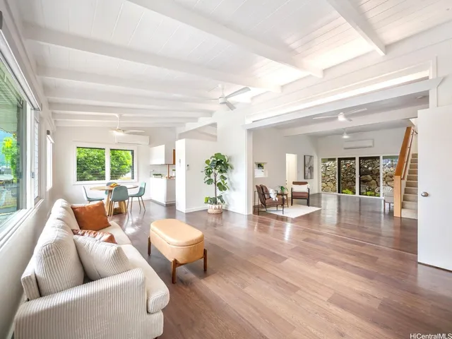 a living room with fireplace furniture and a large window