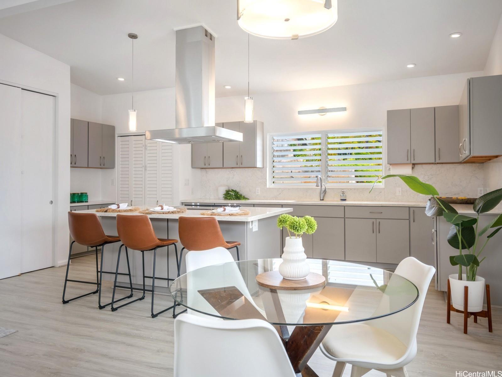 45-185 Lilipuna Road, Unit A Kaneohe, HI 96744 - Photo 5 of 22 a dining room with furniture a large window and wooden floor