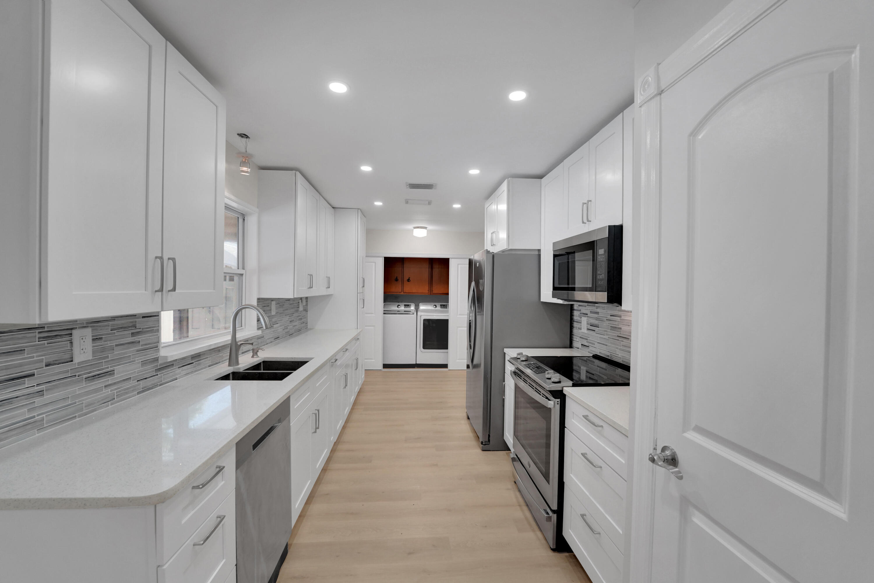600 Northwest 12th Avenue Boca Raton, FL 33486 - Photo 12 of 63 a large kitchen with stainless steel appliances granite countertop a lot of counter space and a sink