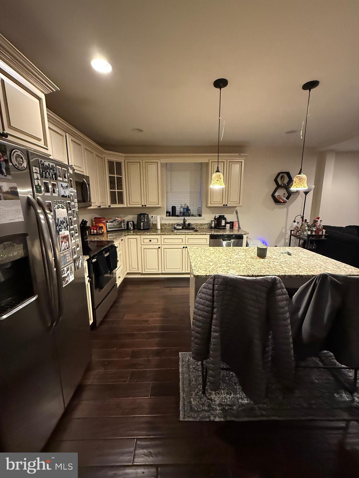 6110 Ridge Avenue Philadelphia, PA 19128 - Photo 2 of 9 a kitchen with kitchen island granite countertop a stove a sink dishwasher a refrigerator with a dining table and chairs