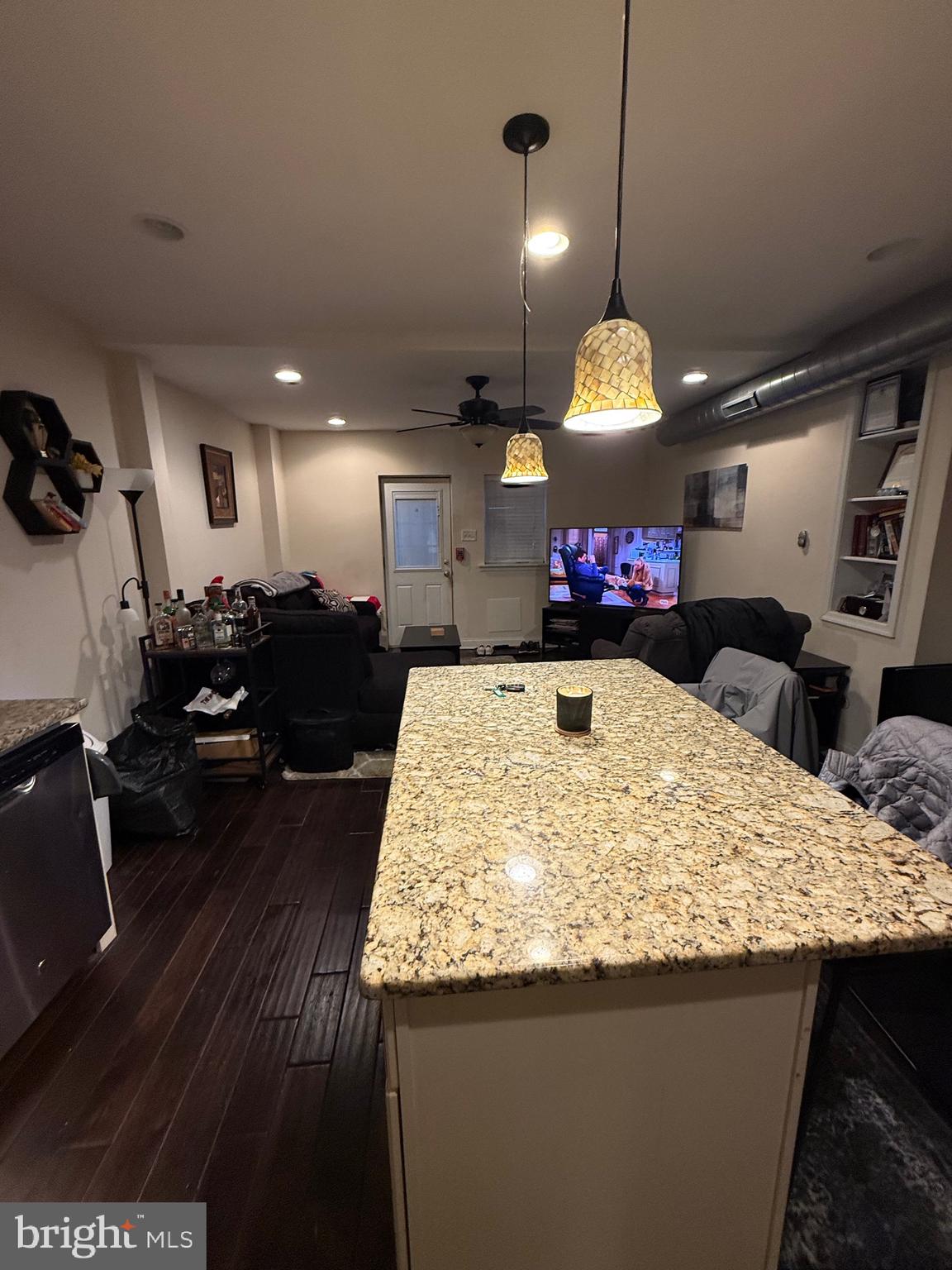 6110 Ridge Avenue Philadelphia, PA 19128 - Photo 4 of 9 a kitchen with kitchen island a stove and a wooden floor