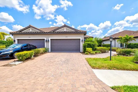 a front view of a house with a yard and garage