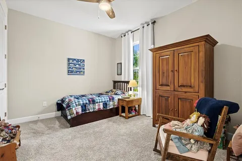 a bedroom with furniture and a lamp