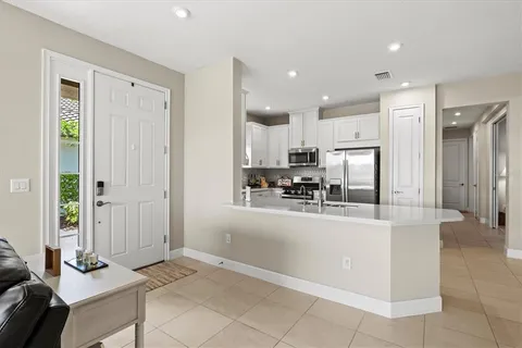 a kitchen with stainless steel appliances granite countertop a refrigerator and a stove top oven