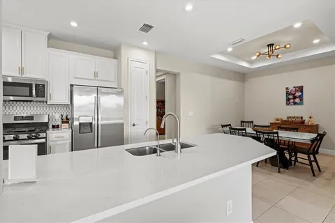 a kitchen with kitchen island a refrigerator stove and microwave