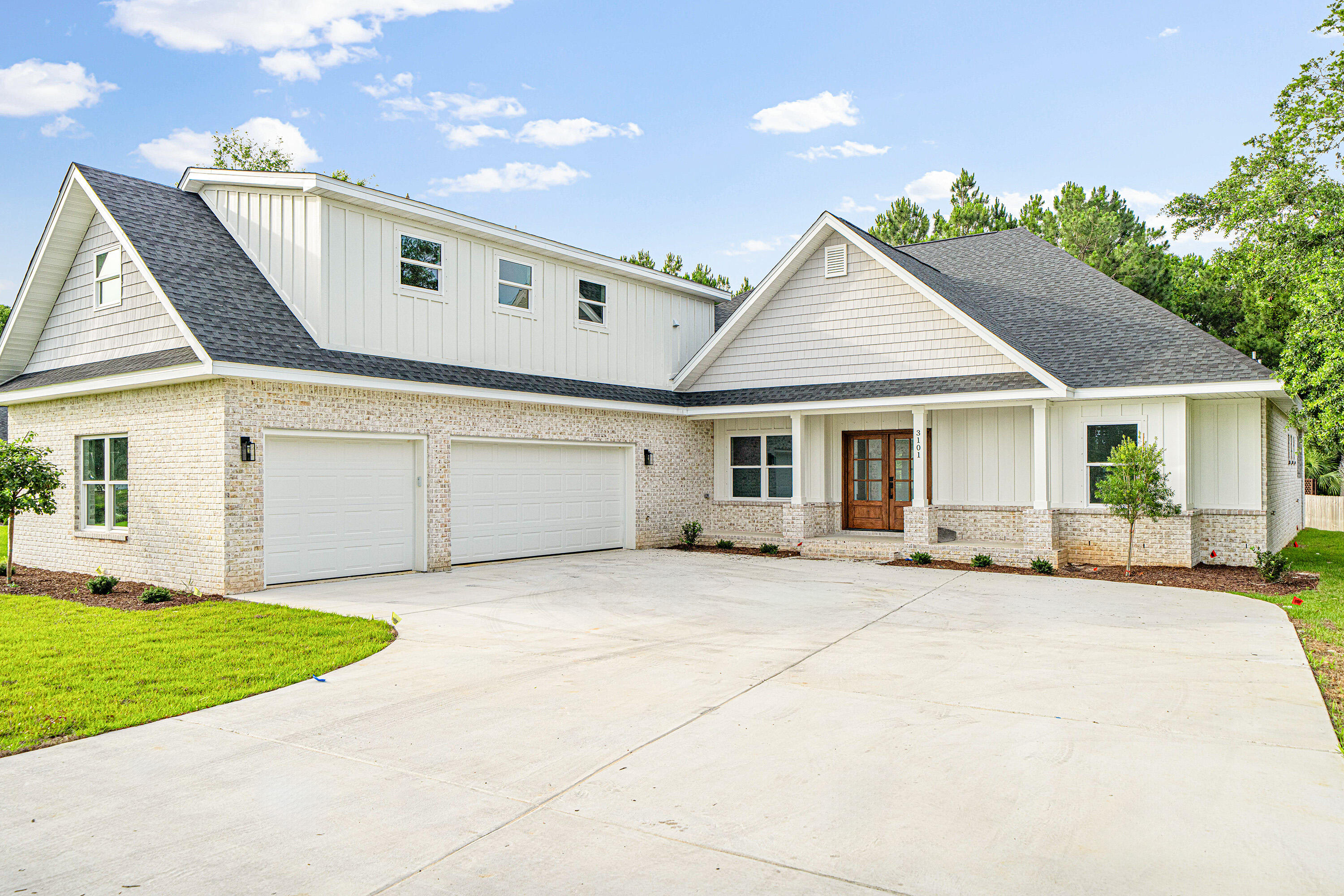 a front view of a house with a garden and yard