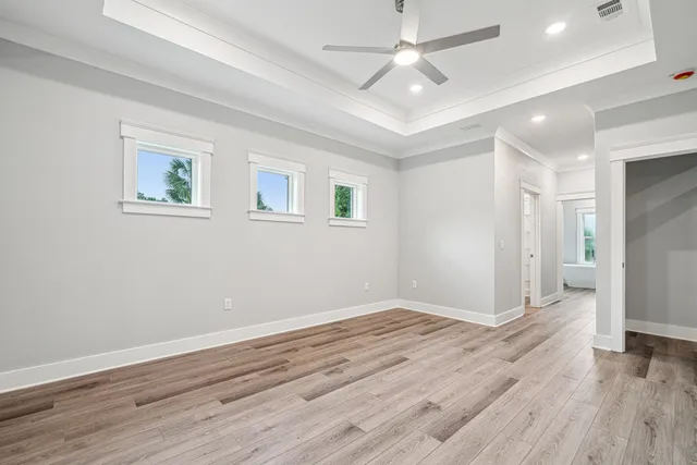 a view of empty room with wooden floor