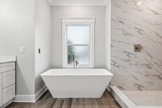 a bathroom with a bathtub and shower