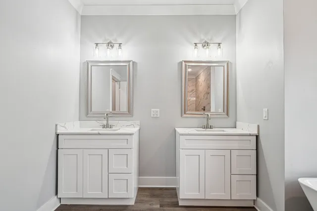 a bathroom with double vanity sink a mirror and a window