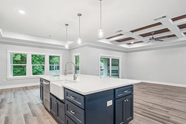 a kitchen with a stove and a wooden floor