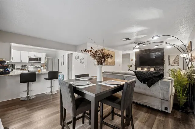 a view of a dining room with furniture window and wooden floor
