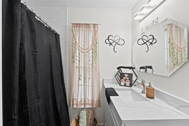 a bedroom with a bed tv and a chandelier
