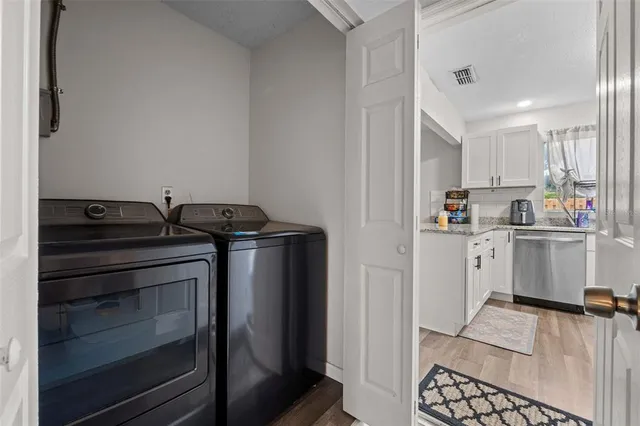 a bedroom with furniture a chandelier and a flat screen tv