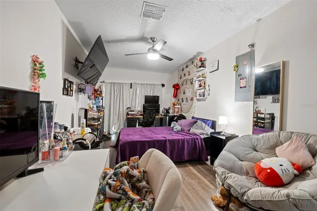 a bedroom with a bed tv and a window