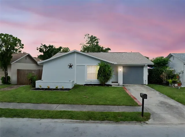 a front view of a house with a garden and yard