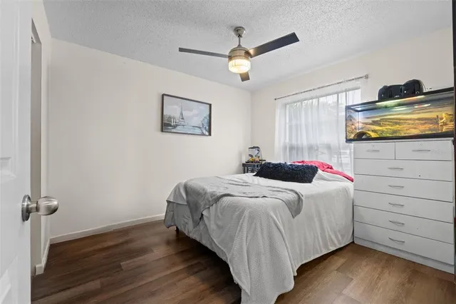 a kitchen with granite countertop a refrigerator a stove a sink dishwasher and a stove with wooden floor