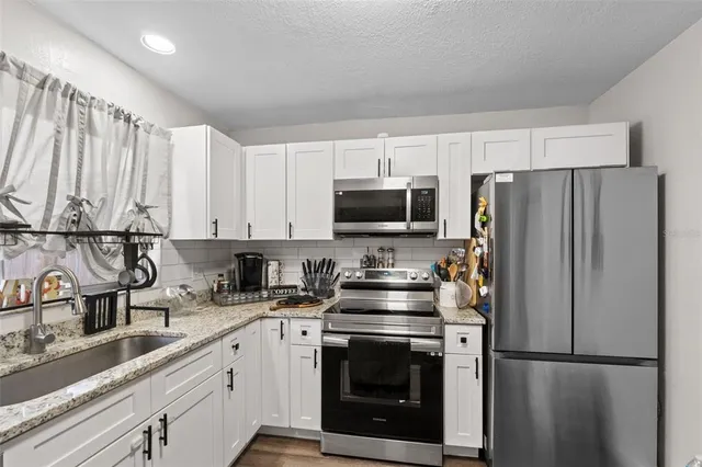 a building outdoor space with patio furniture and potted plants