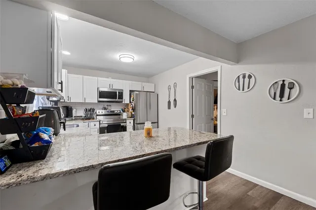 a view of a house with pool and chairs