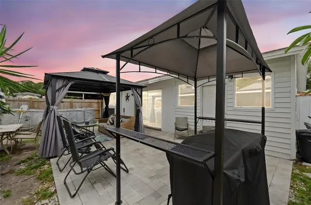 a view of a house with pool and a yard