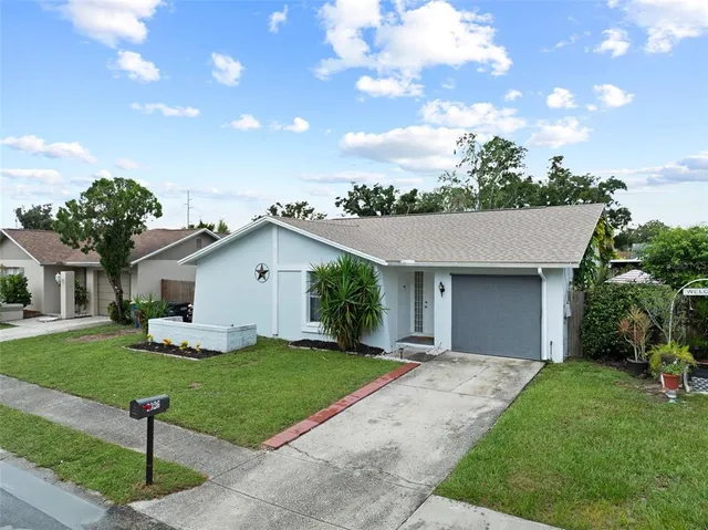 a front view of house with yard and green space