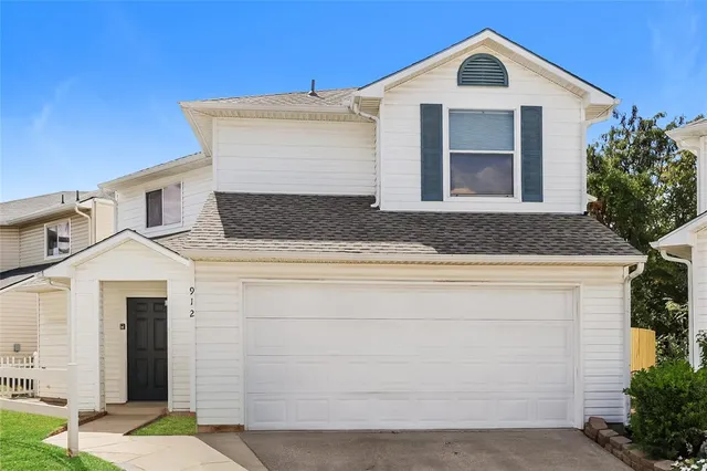 a front view of a house with garage