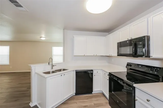 a kitchen with a sink stove and microwave