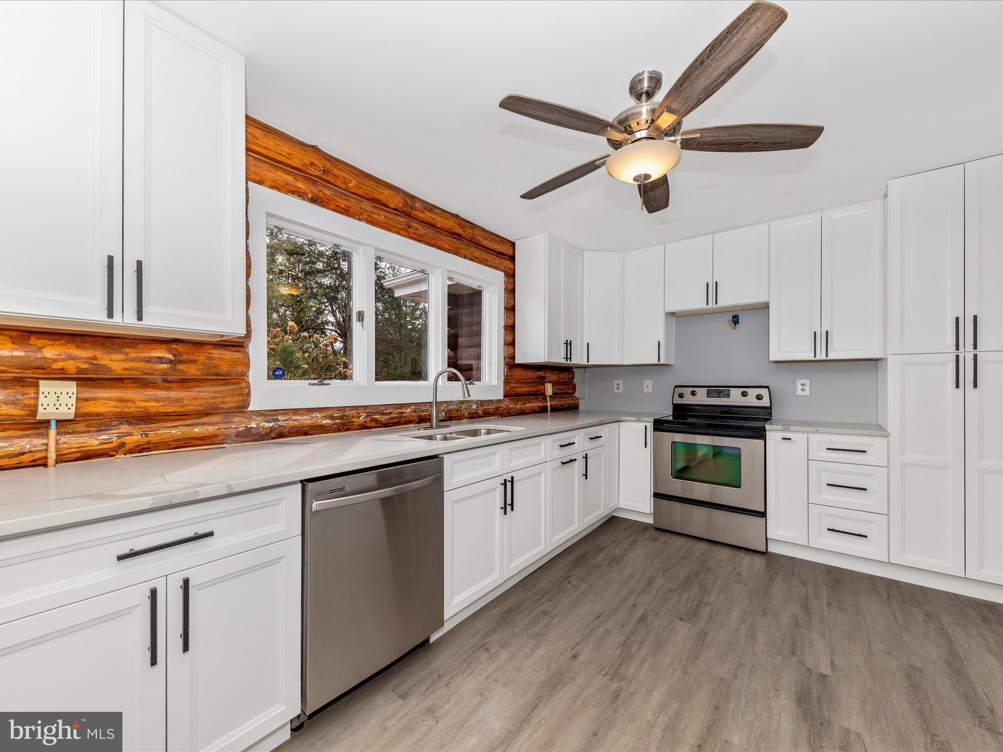 9513 Huntmaster Road Gaithersburg, MD 20882 - Photo 12 of 51 a kitchen with cabinets a sink and appliances