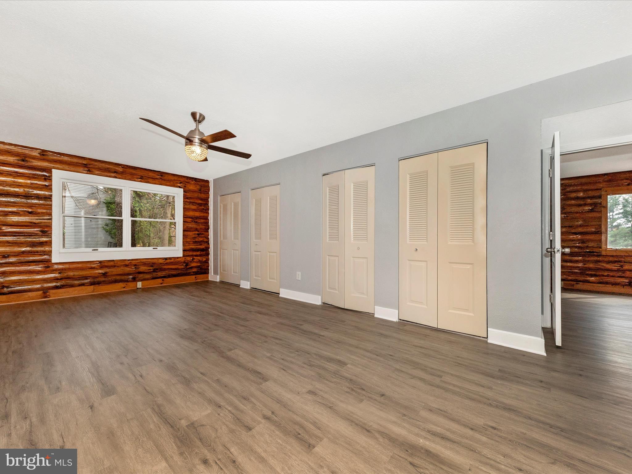 9513 Huntmaster Road Gaithersburg, MD 20882 - Photo 17 of 51 a view of an empty room with wooden floor and a window