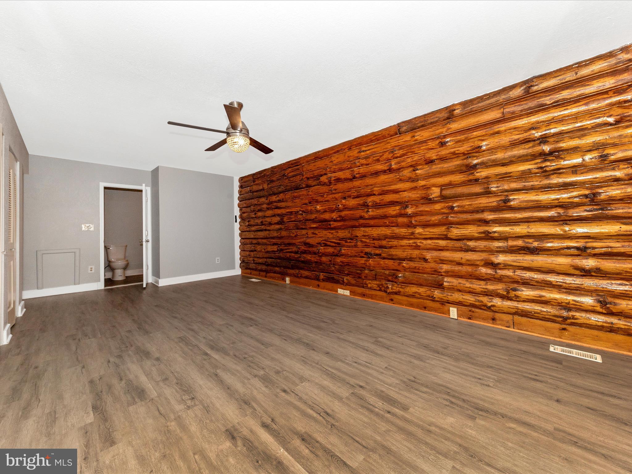 9513 Huntmaster Road Gaithersburg, MD 20882 - Photo 19 of 51 a view of room with wooden floor and ceiling fan