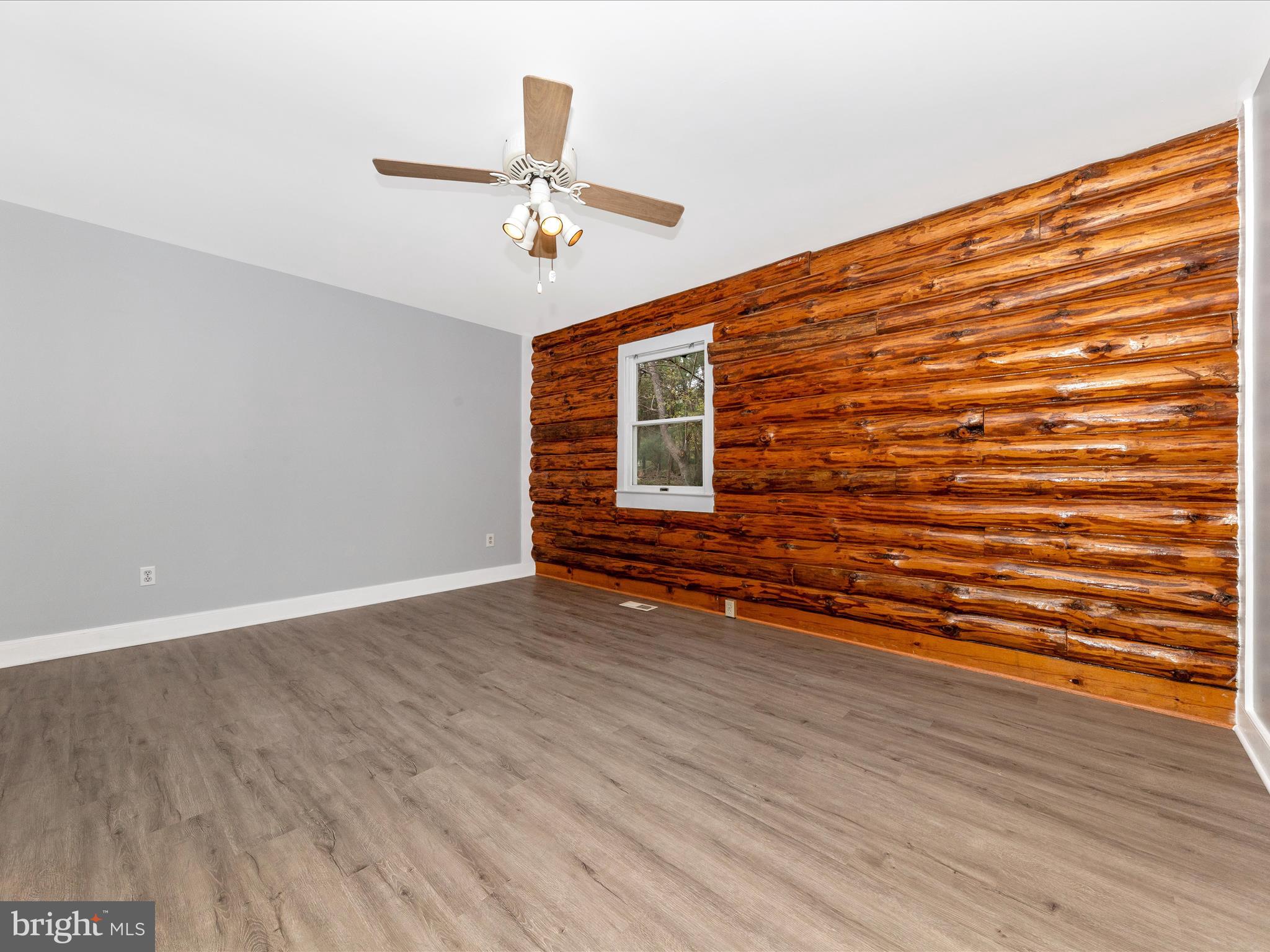 9513 Huntmaster Road Gaithersburg, MD 20882 - Photo 22 of 51 a view of empty room with wooden floor and fan