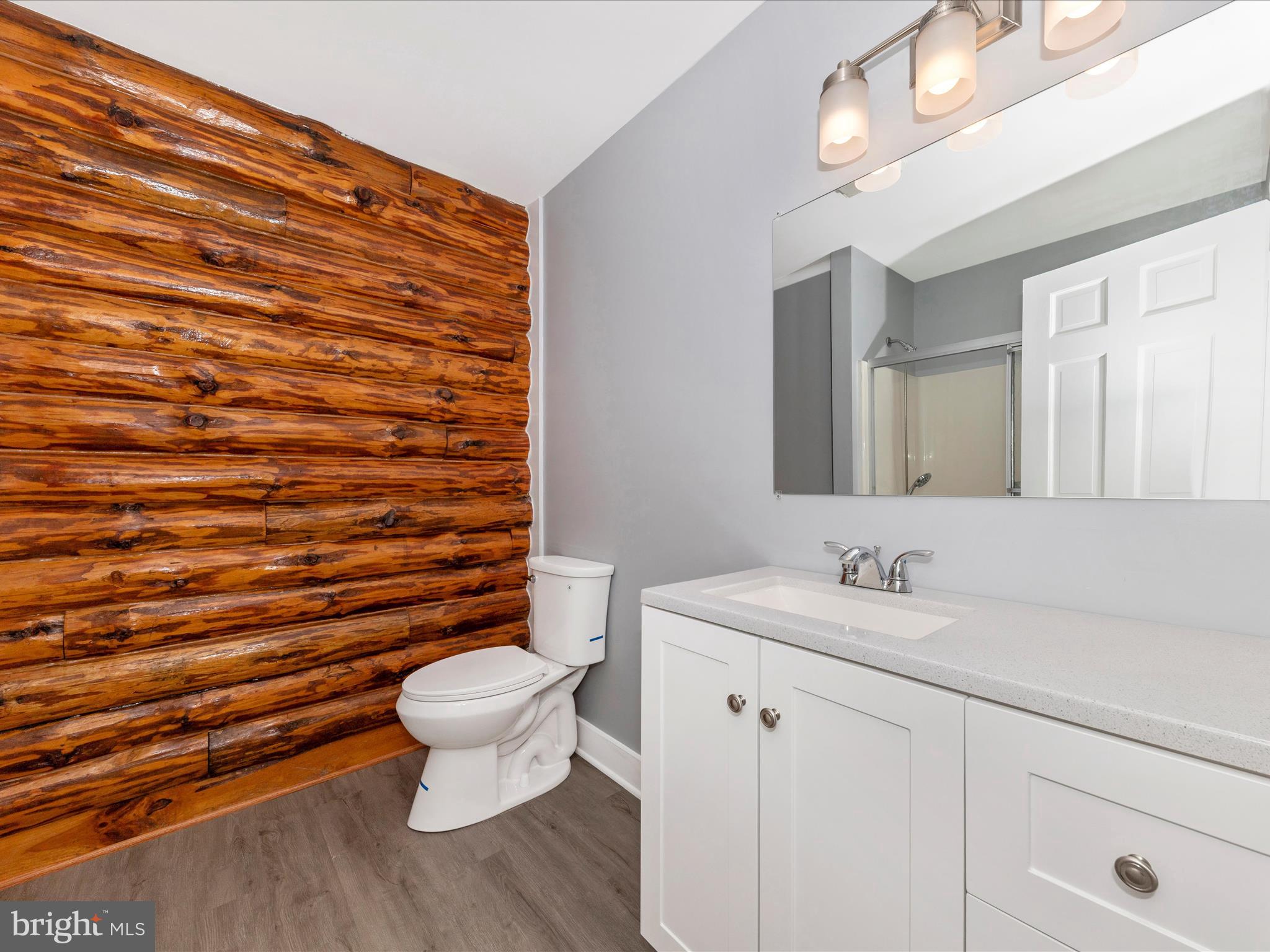 9513 Huntmaster Road Gaithersburg, MD 20882 - Photo 26 of 51 a bathroom with a toilet a sink and mirror