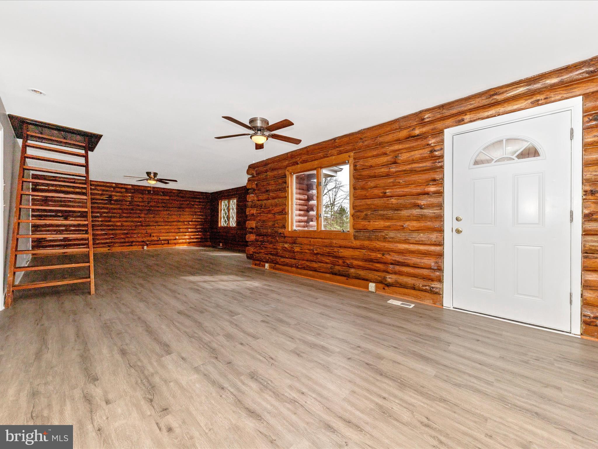 9513 Huntmaster Road Gaithersburg, MD 20882 - Photo 3 of 51 an empty room with wooden floor and windows