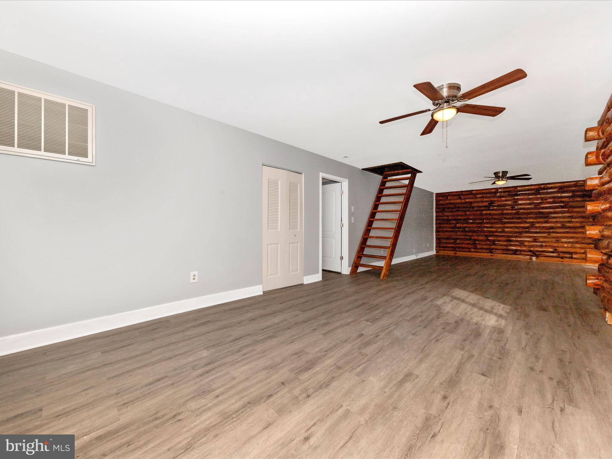 9513 Huntmaster Road Gaithersburg, MD 20882 - Photo 4 of 51 a view of empty room with wooden floor and ceiling fan