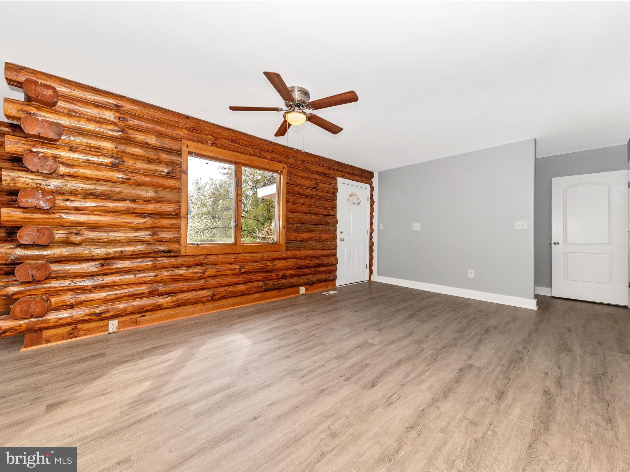 9513 Huntmaster Road Gaithersburg, MD 20882 - Photo 5 of 51 a view of empty room with wooden floor and fan