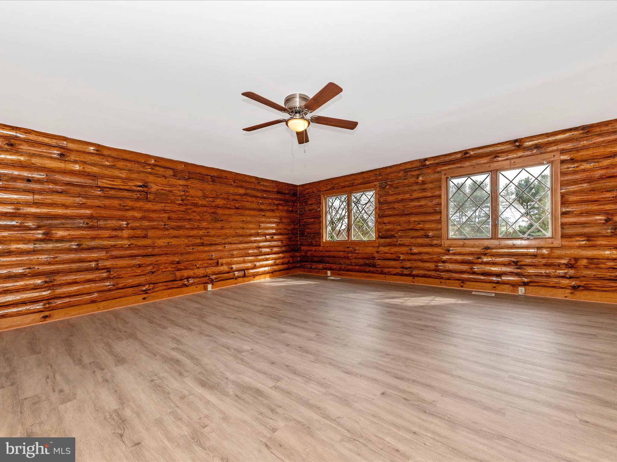 9513 Huntmaster Road Gaithersburg, MD 20882 - Photo 6 of 51 a view of a livingroom with wooden floor and a ceiling fan