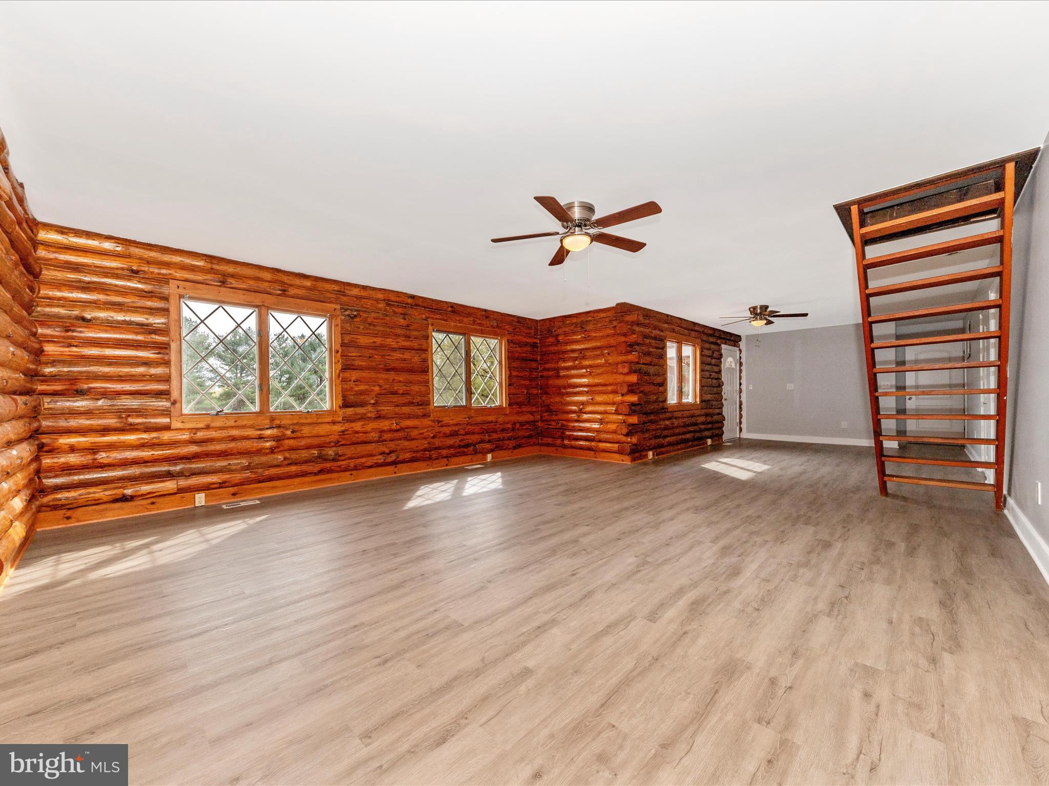 9513 Huntmaster Road Gaithersburg, MD 20882 - Photo 10 of 51 wooden floor in an empty room with a window