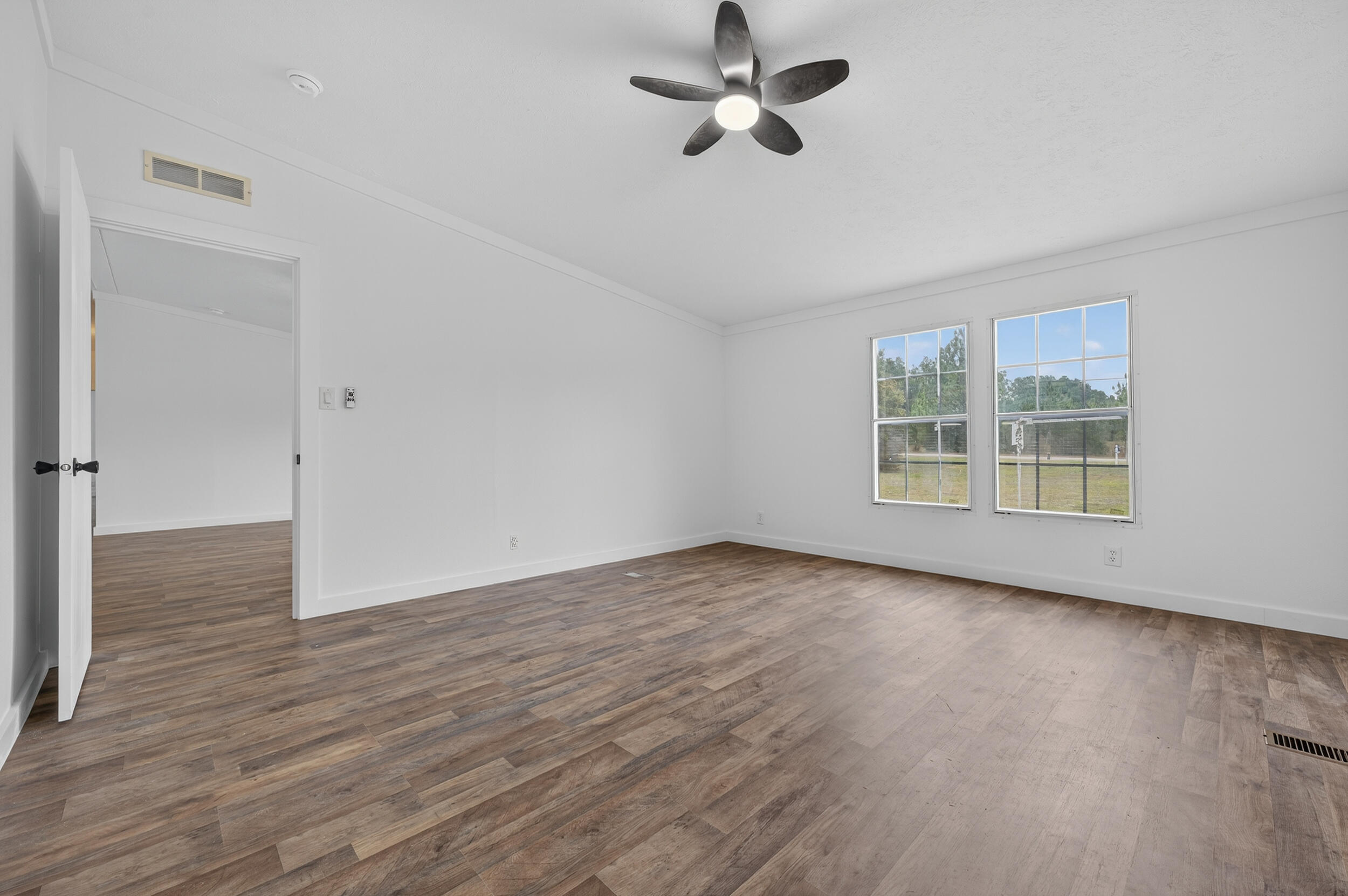 4580 Rainbird Rise Road Crestview, FL 32539 - Photo 23 of 41 a view of empty room with wooden floor and fan