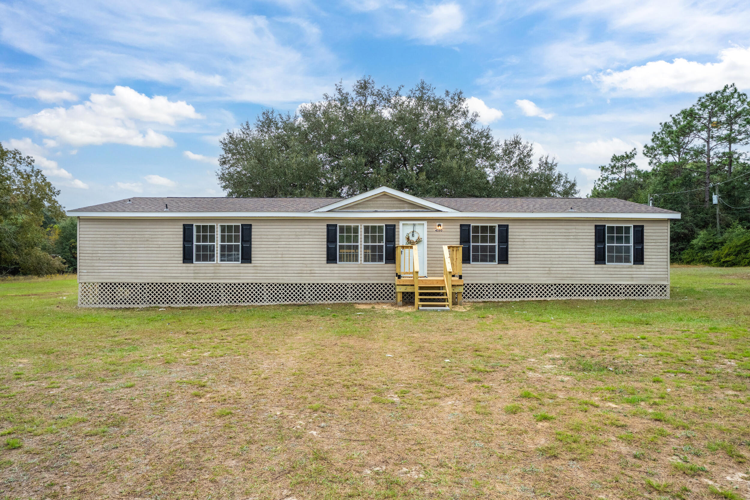 4580 Rainbird Rise Road Crestview, FL 32539 - Photo 4 of 41 a swimming pool with outdoor seating and yard