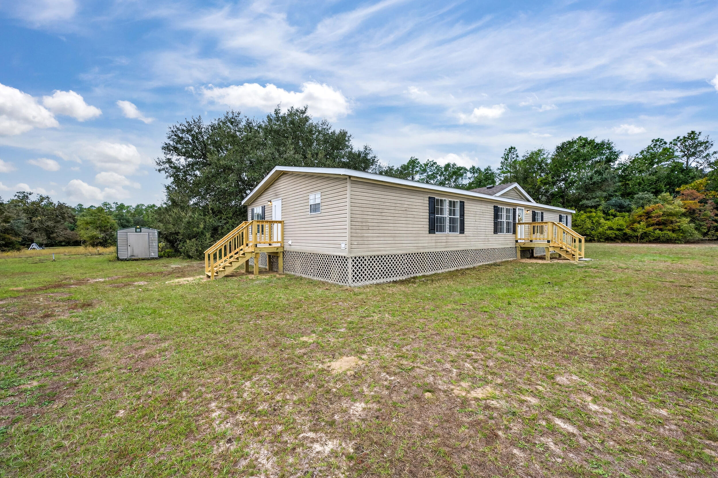 4580 Rainbird Rise Road Crestview, FL 32539 - Photo 5 of 41 a view of a house with backyard and garden