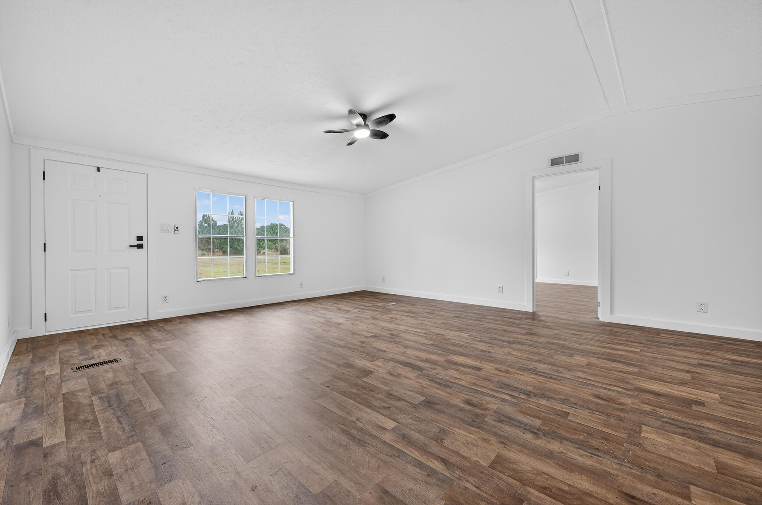 4580 Rainbird Rise Road Crestview, FL 32539 - Photo 6 of 41 wooden floor in an empty room with a window