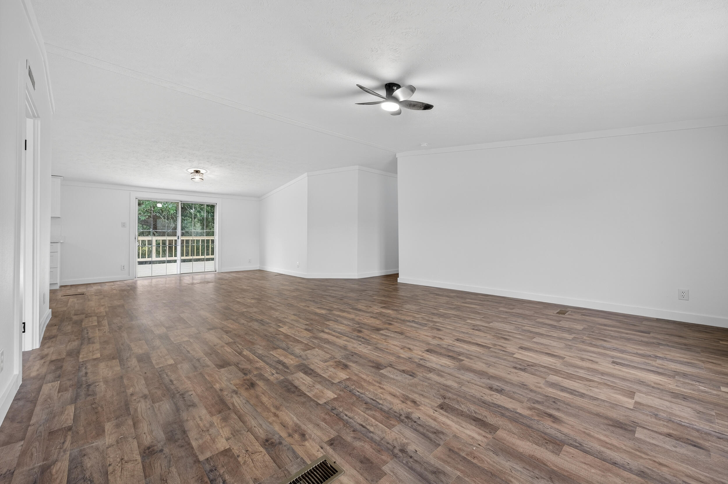 4580 Rainbird Rise Road Crestview, FL 32539 - Photo 8 of 41 a view of empty room with wooden floor and fan