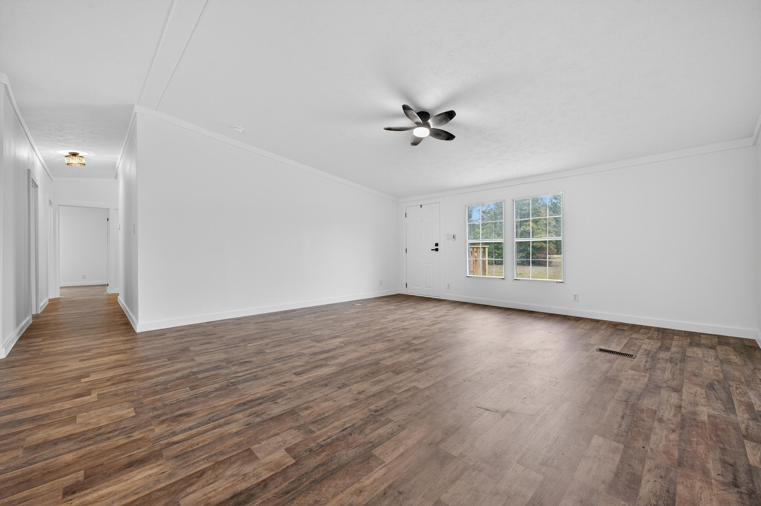 4580 Rainbird Rise Road Crestview, FL 32539 - Photo 9 of 41 wooden floor in an empty room with a window