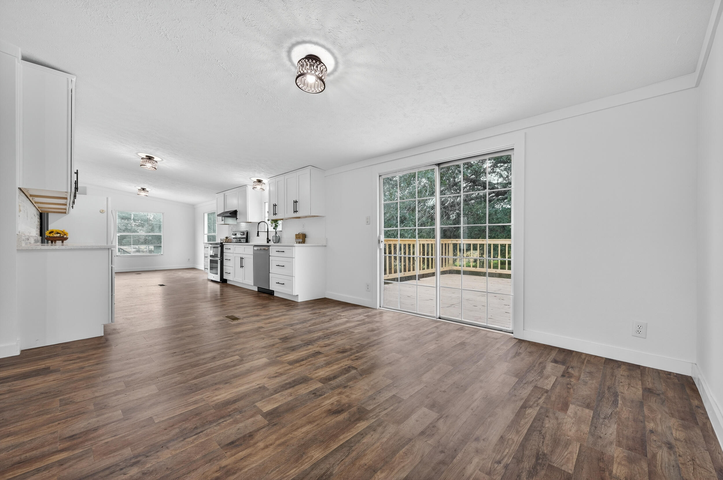 4580 Rainbird Rise Road Crestview, FL 32539 - Photo 10 of 41 a view of empty room with wooden floor and windows