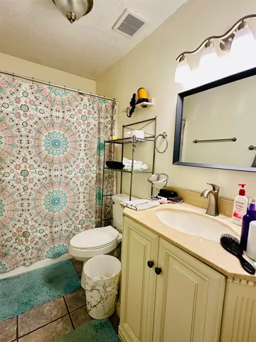 a bathroom with a sink toilet and a mirror